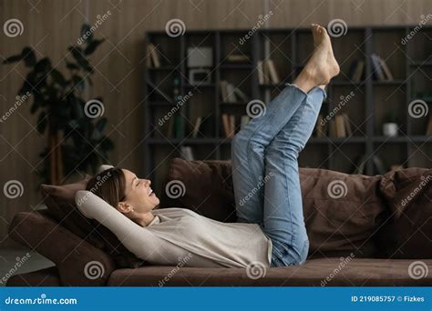 Casual Young Female Relax Barefoot On Couch Raise Legs Up Stock Image Image Of Exercises Flat