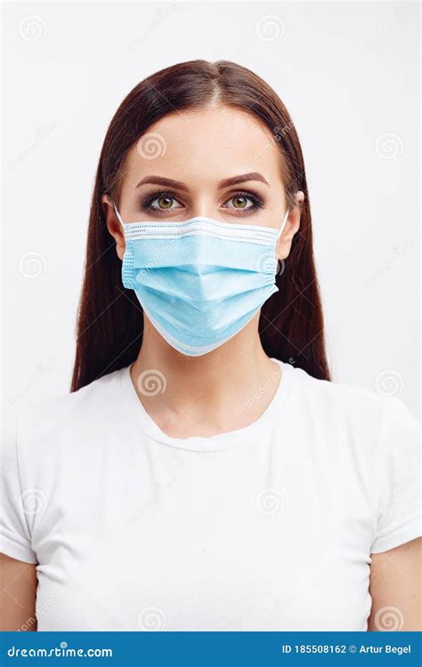 Brunette Woman Wearing Disposable Mask Looks With An Angry Eyes Stock