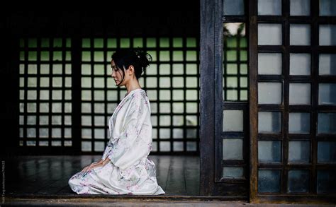 Beautiful Japanese Woman In Casual Silky Kimono Sitting In Traditional Japanese House By