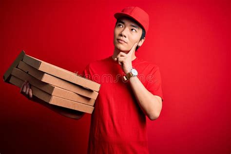 Young Handsome Chinese Delivery Man Holding Deliver Boxes With Italian