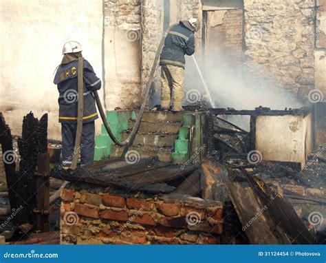 Fireman Spraying Water Firefighters Extinguish A Fire In An Apa Stock