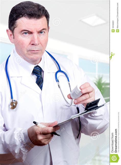 Serious doctor with pills stock image. Image of isolated - 18166891