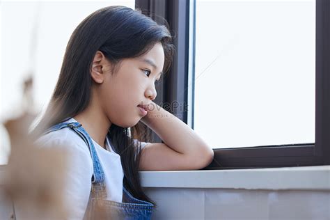 Lonely Little Girl Lying In Front Of The Window Picture And Hd Photos