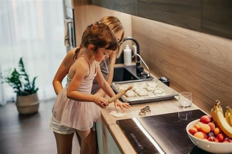 Premium Photo A Woman And Her Little Daughter Cooking Delicious