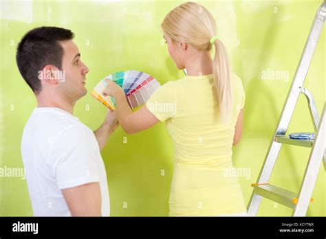 Couple Choosing Paint Man Making Face He Not Like The Chosen Color