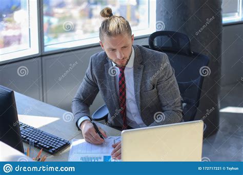 Young Modern Business Man Working Using Laptop While Sitting In The
