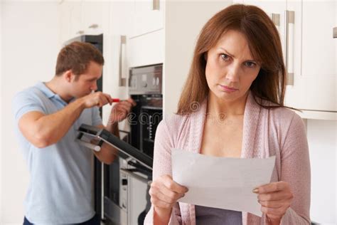 Woman Looking Concerned At Domestic Repair Bill Stock Image Image Of