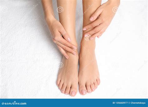 Woman Touching Her Smooth Feet On White Towel Closeup Stock Image