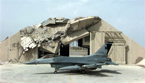 An F 16c Fighting Falcon In Front Of A Destroyed Hardened Aircraft