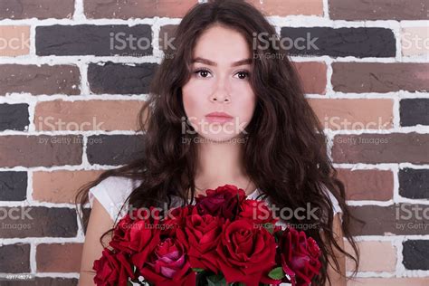 Thoughtful Girl With Red Roses Bouquet Stock Photo Download Image Now