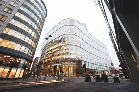 Long Exposure Of New Modern Building With Glass Facade And Lights On