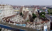 an amusement park with several roller coasters in the foreground and ...