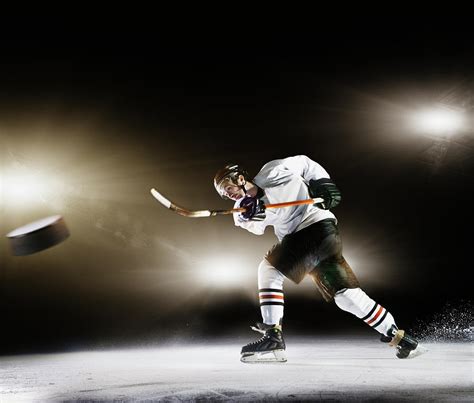 Ice Hockey Player Shooting Puck Photograph By Robert Decelis Ltd Pixels