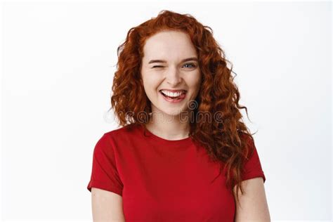 Close Up Of Cheerful Silly Redhead Girl Showing Tongue Smiling With Perfect Teeth And Winking