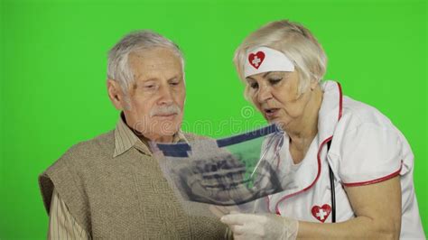 Mature Woman Nurse Doctor Examines Senior Patient Man With Problems