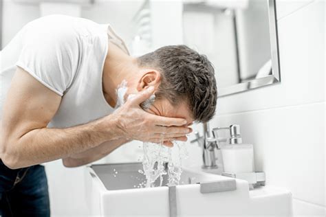 Man Washing Face In The Bathroom Stock Photo Download Image Now Istock