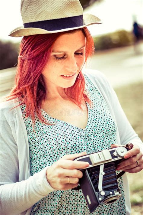 Attractive Smiling Redhead About To Settle Her Old Camera Vintage