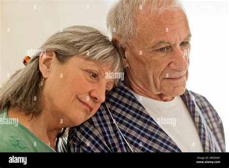 Senior Woman Comforting Her Ailing Husband Stock Photo Alamy