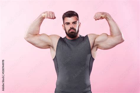 Strong Man A Bodybuilder Flexing His Biceps Showing Off His Big Arms