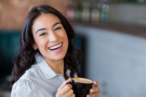 Premium Photo Portrait Of Smiling Woman Having Cup Of Coffee