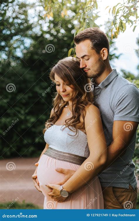 Husband Is Embracing His Beautiful Pregnant Wife From Behind Stock Image Image Of Bonding