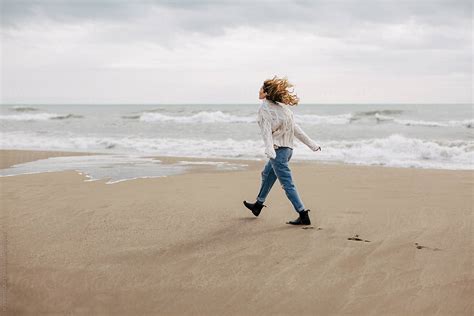 Alone Woman Walking On The Beach In Winter By Stocksy Contributor