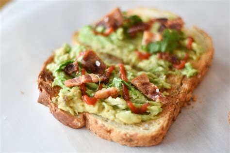 Avocado Toast With Bacon And Sriracha With Two Spoons