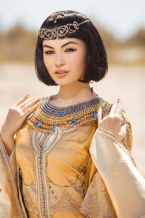 beautiful woman fashion make up hairstyle like egyptian queen cleopatra outdoors against desert