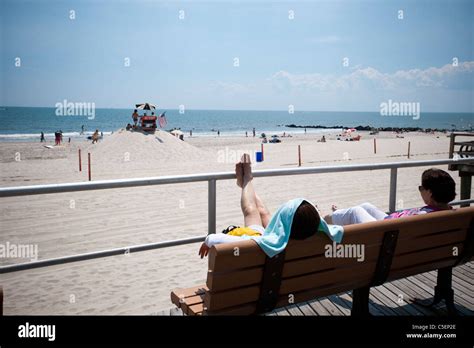 Beachgoers Take Advantage Of The Warm Summer Sun At The Beach At The
