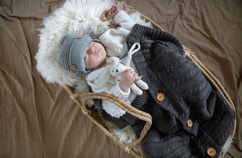 Premium Photo The Baby Sleeps Sweetly In A Wicker Cradle In A Warm