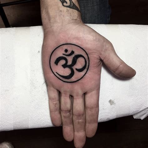 Om Symbol In A Circle Tattoo On The Palm