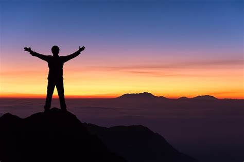 Premium Photo Silhouette Of Man Standing And Spread Hand On The Top