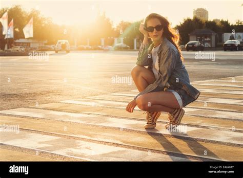 Lovely Teenager Girl Posing At The Crosswalk In The Sunset Happy