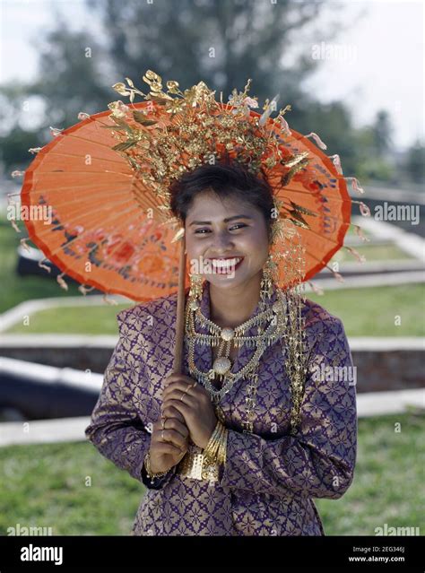 Asia Malaysia Penang Portrait Of A Smiling Pretty Malaysian Girl Wearing Traditional Dress