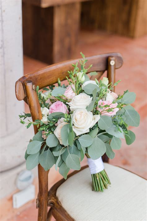 bridal bouquet with eucalyptus white roses and blush flowers from this destination wedding in