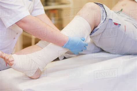 Nurse Bandages The Leg Fracture Of Human Lower Limbs Treatment Of Broken Bones Impose A