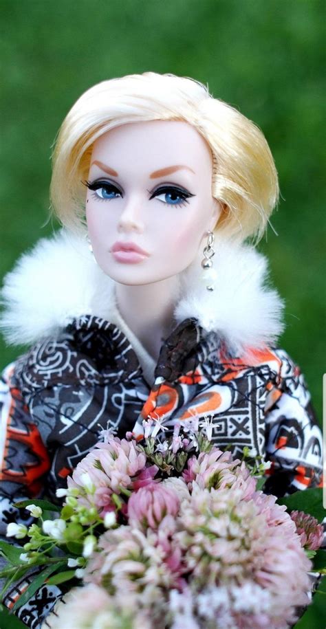 A Barbie Doll Holding A Bouquet Of Flowers