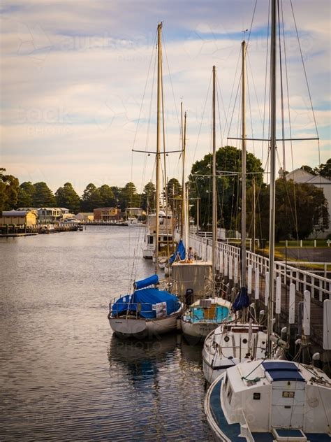 Image of Wharf and yachts docked in river in fishing village of Port ...