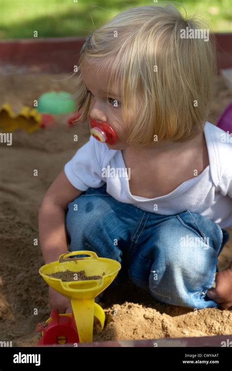 Baby Toddler Blond Girl Playing In Sandbox Summer Stock Photo Alamy