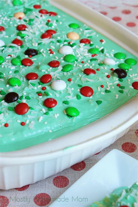 Strawberry gelatin and strawberries liven up each pretty slice of this lovely layered strawberry poke cake that's made from a convenient boxed mix. Christmas Coconut Poke Cake | Mostly Homemade Mom