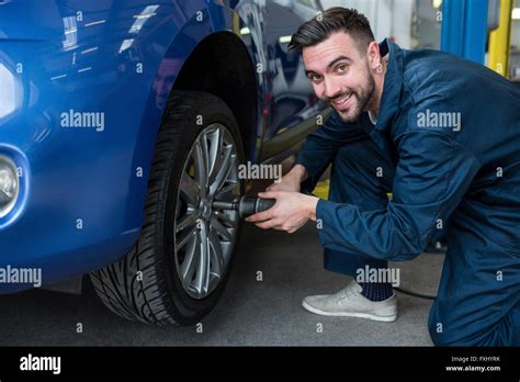 Mechanic Fixing A Car Wheel Stock Photo Alamy