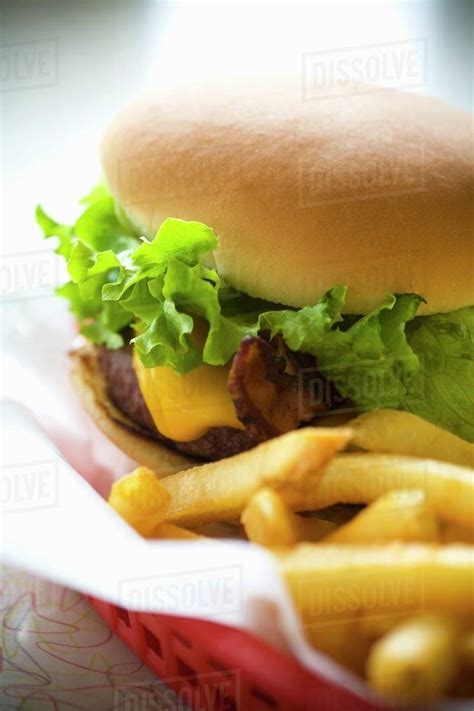 Cheeseburger And Fries In A Red Basket Stock Photo Dissolve