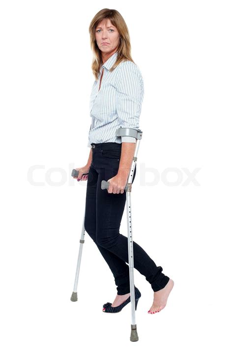Pensive Looking Woman Using Crutches To Walk Stock Image Colourbox