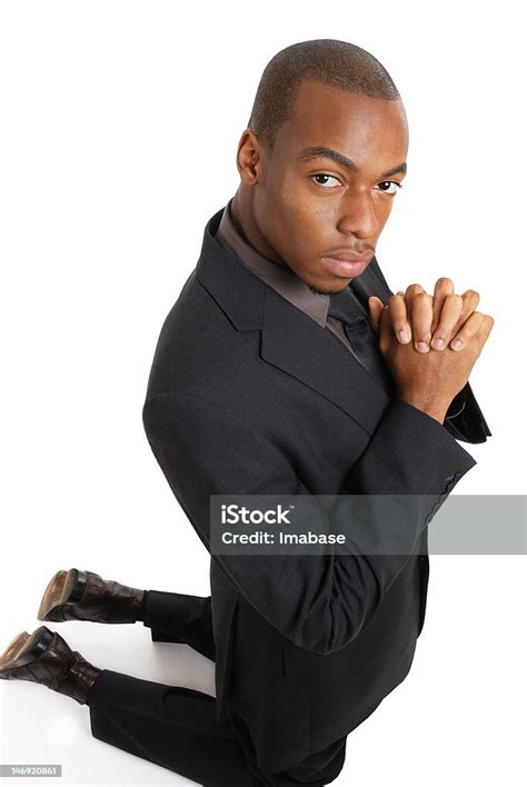 Business Man Kneeling Doing A Prayer Gesture Stock Photo Download