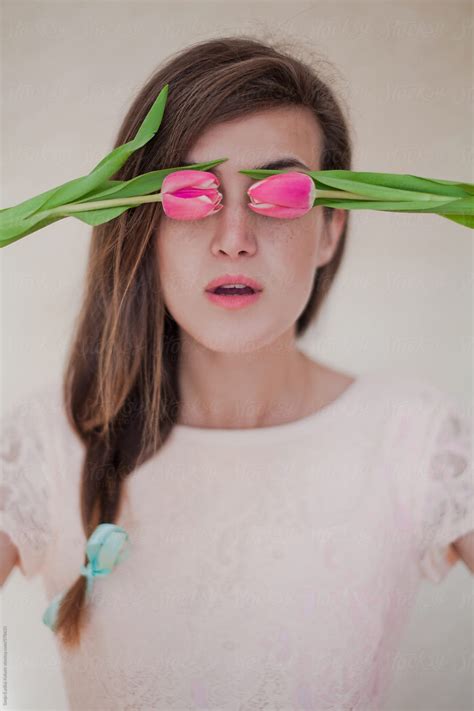 Cute Vintage Girl With Braid And Fresh Pink Tulips Over Her Eyes By