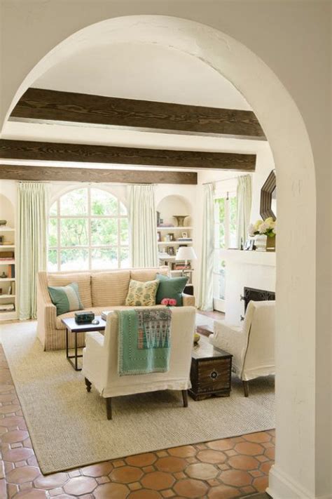 Mediterranean Living Room With Wood Ceiling Beams And Arched Doorway