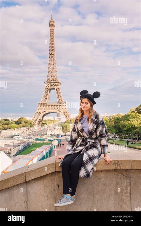 Beautiful Girl Sitting In Paris Against The Backdrop Of The Eiffel