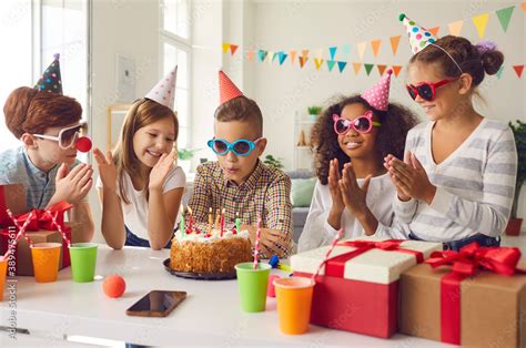 Group Of Kids Celebrating Their Friends Birthday And Clapping Hands As