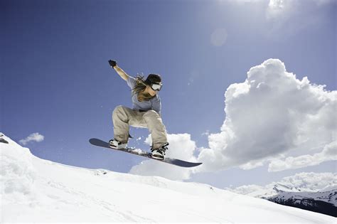 Female Snowboarder Jumping Through Air 88888350 599727b9845b340011d830a5 