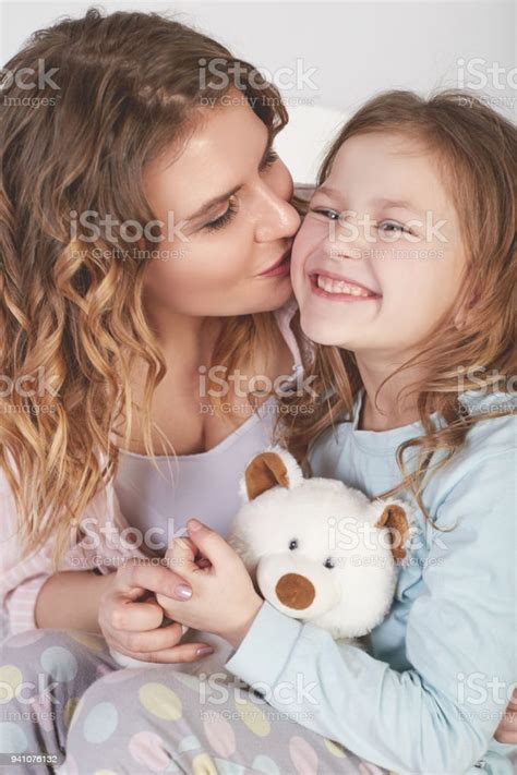 Happy Mother Kissing Her Daughter Stock Photo Download Image Now